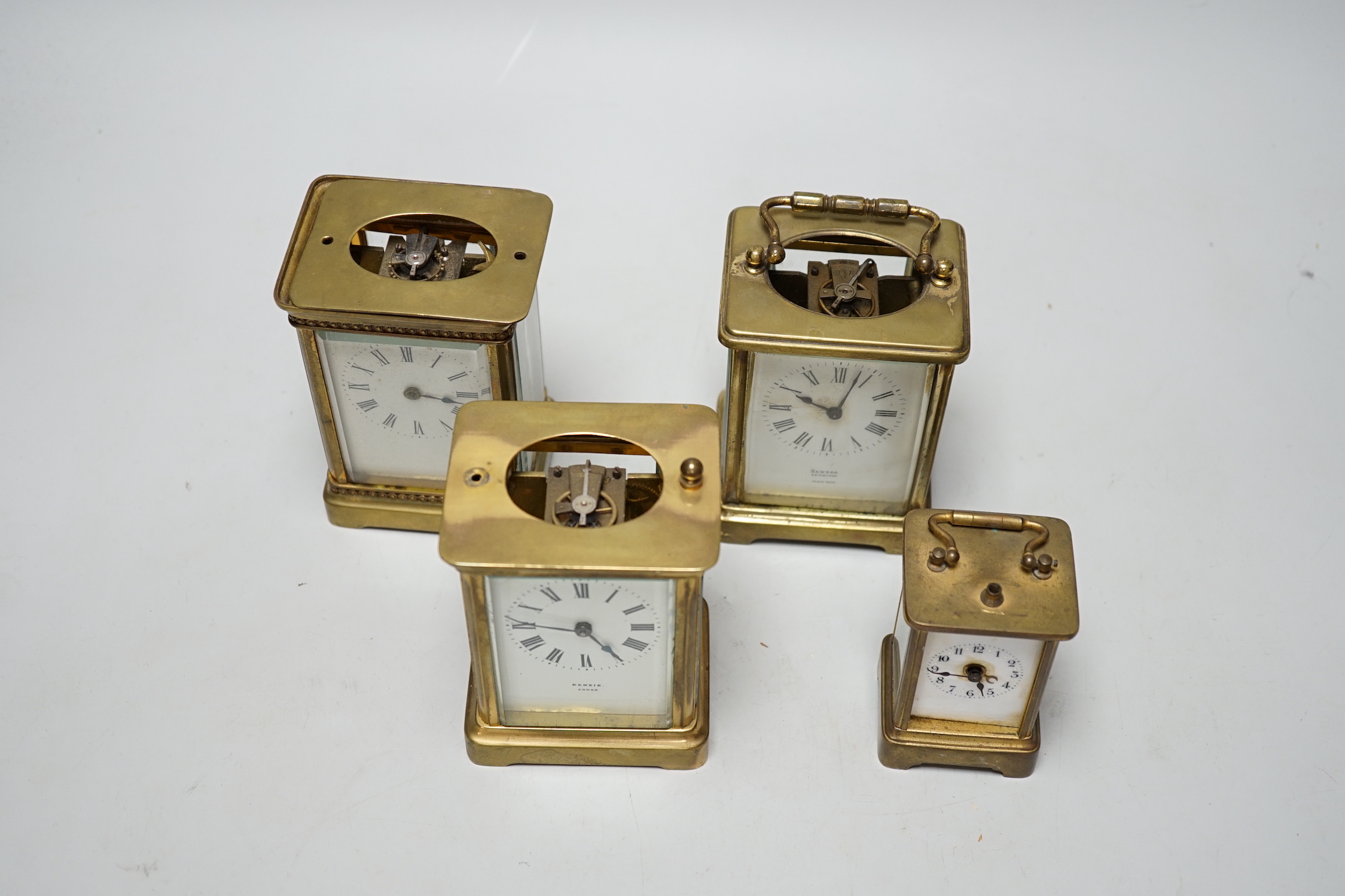 Four carriage clocks in varying sizes, tallest 12cm high